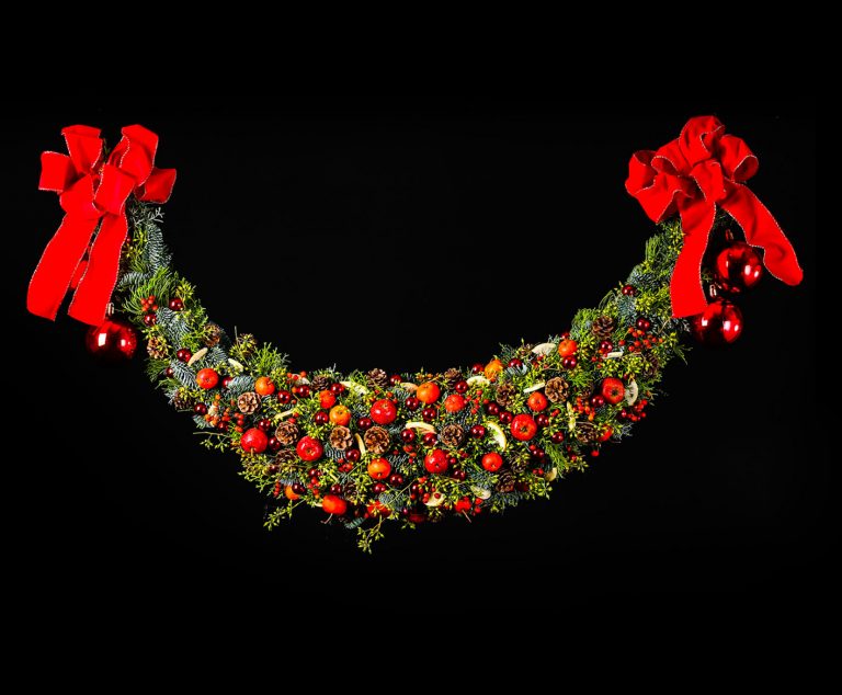 Another classical Christmas decoration is a garland. Also decorated in traditional red and green.