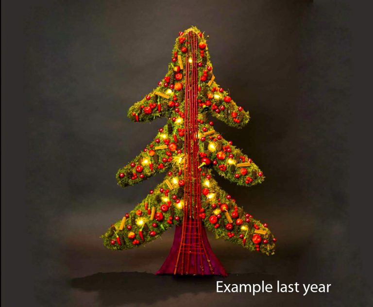 Alternative christmas tree made of green moss and red decoration