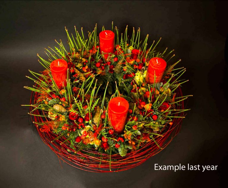 classic wreath with 4 red candles and typical decoration with a cornus collar