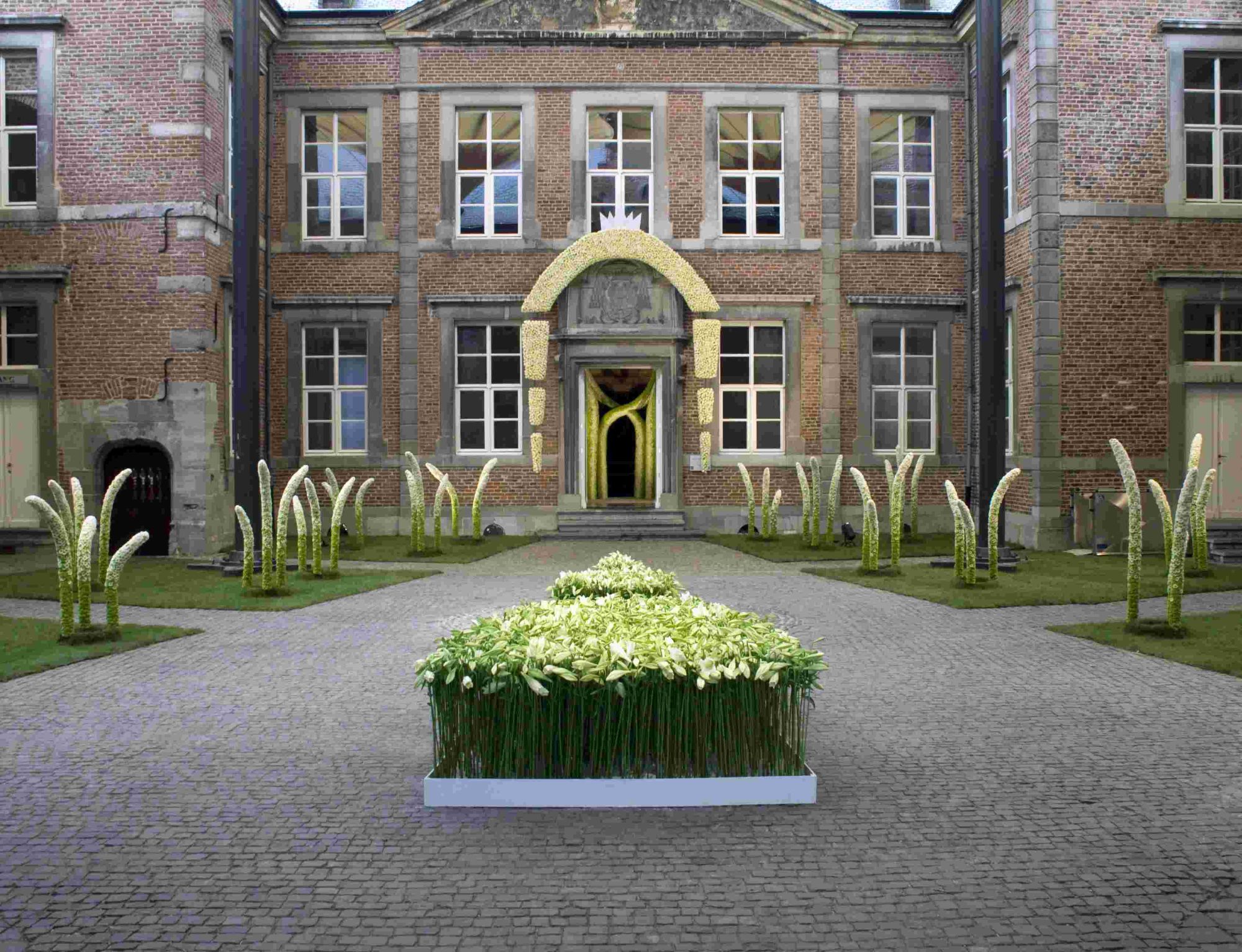 The central place of the medieval castle of Alden Biesen, Belgium. A modern approach of a decoration with white and green.